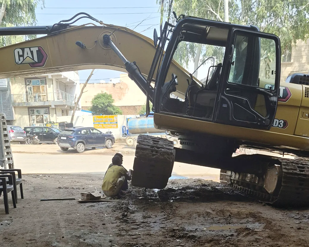 A CAT excavator at the yard entrance